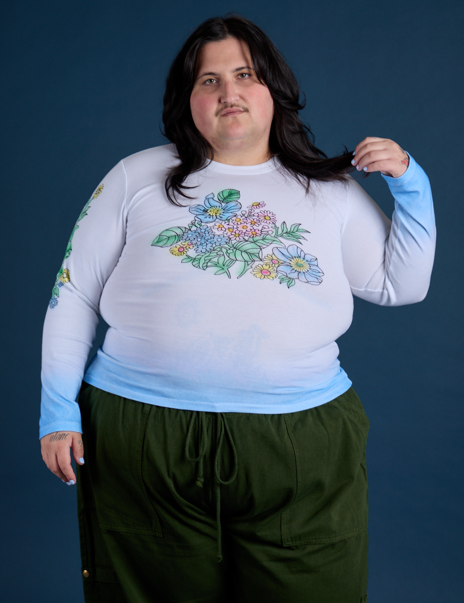 Sam is 5’10” and wearing XL Floral Long Sleeve Baby Tee in Baby Blue