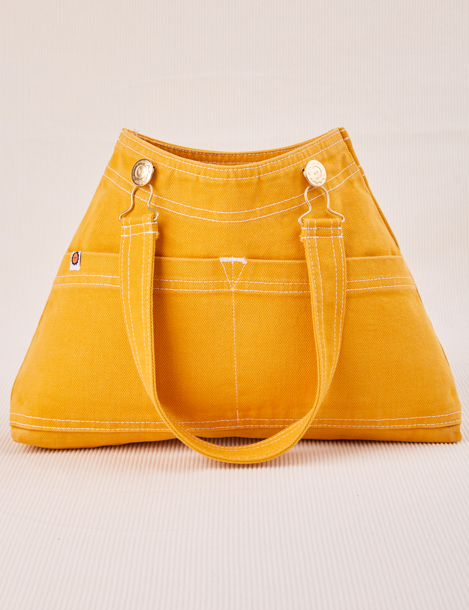 Overall Handbag in Mustard Yellow with handle strap down