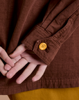 Sleeve close up with yellow button on Ripstop Field Coat in Fudgesicle Brown 