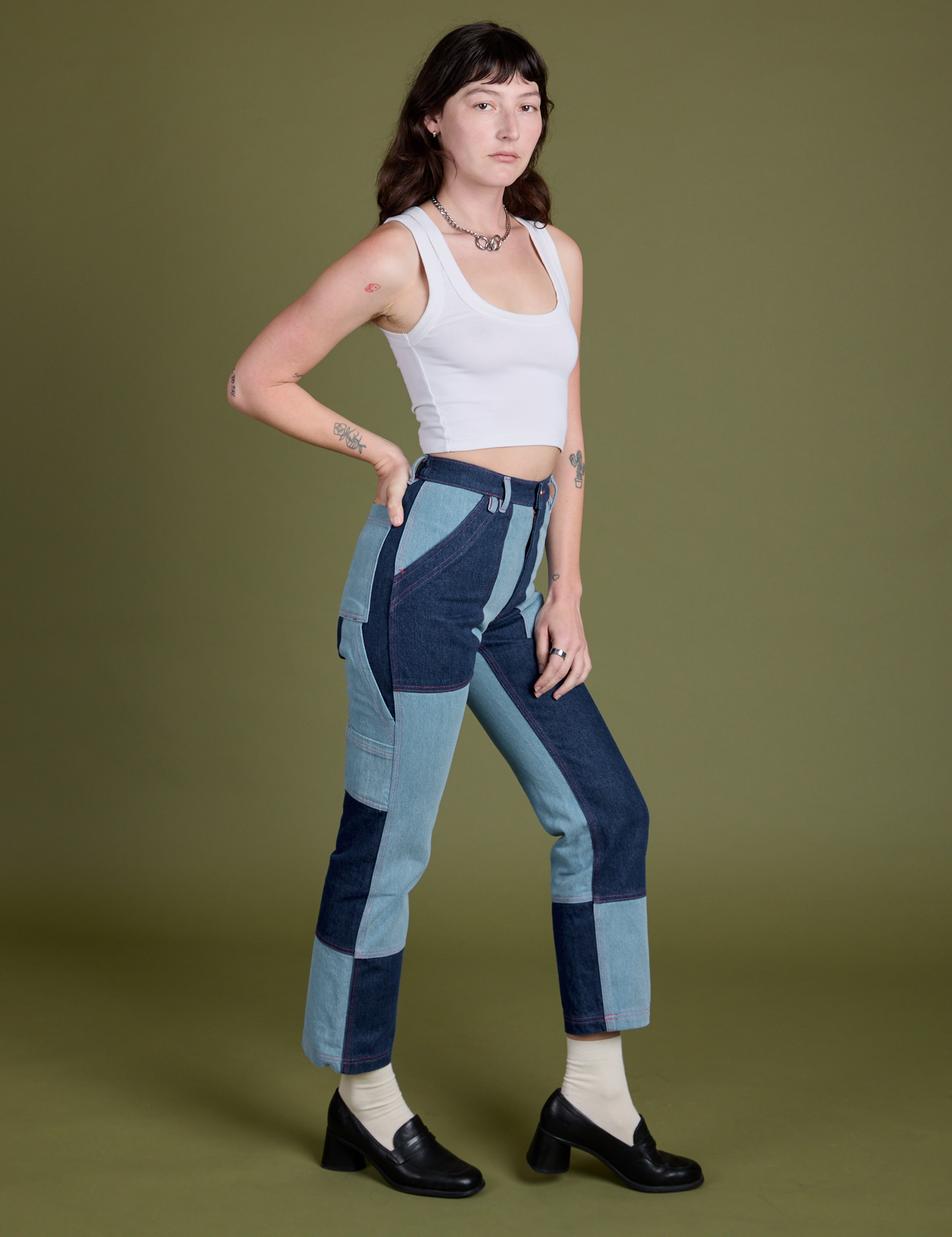Angled front view of Mismatched Denim Carpenter Jeans and Cropped Tank in Vintage Tee White on Alex