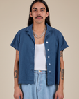 Anthony is 5’6” and wearing S Pantry Button-Up in French Blue