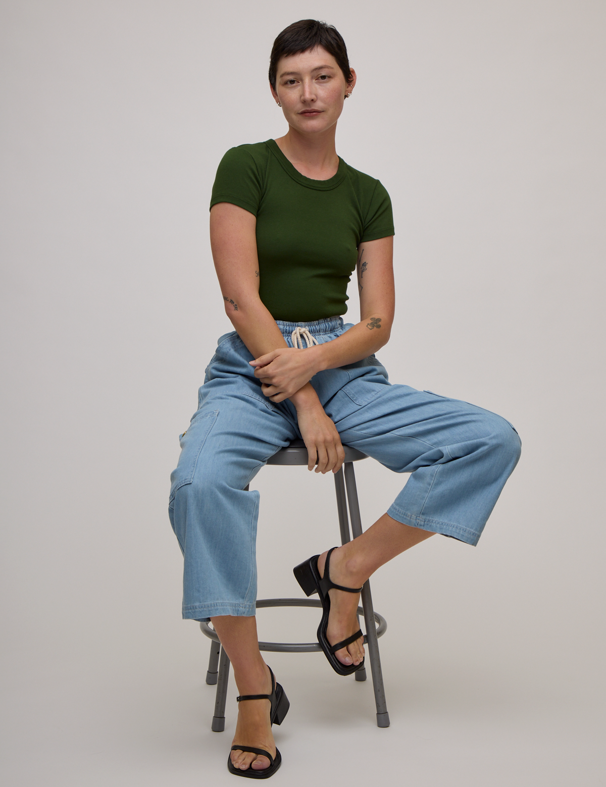 Baby Tee in Evergreen and light wash denim drop pocket pants on Alex
