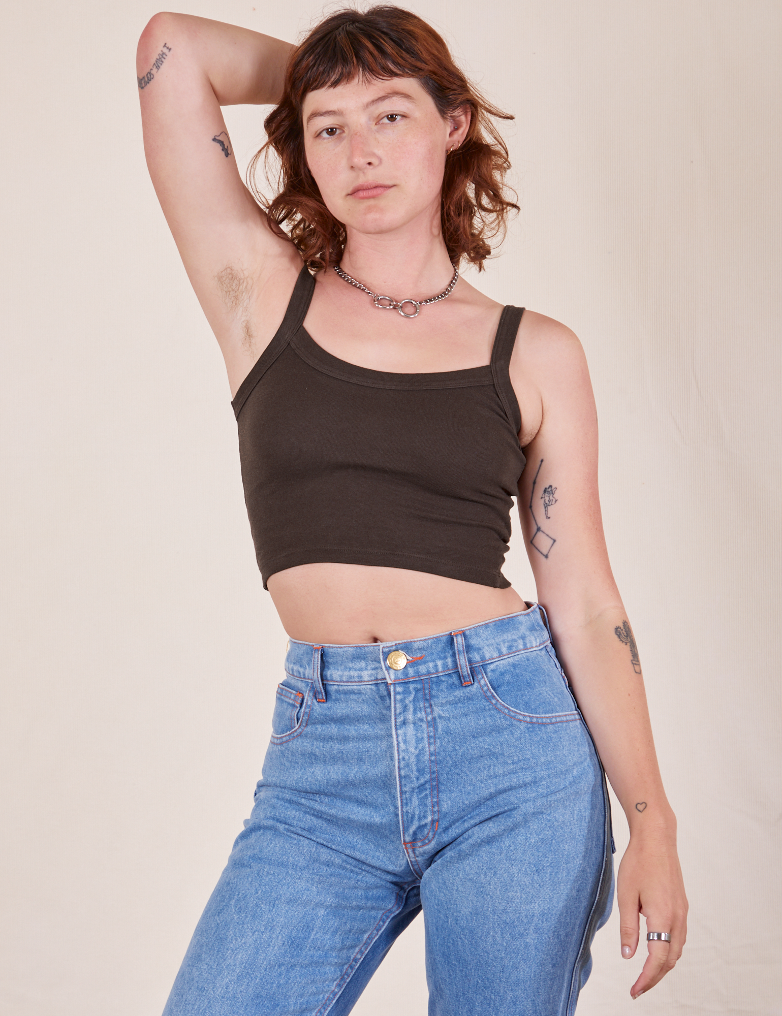 Alex is 5'8" and wearing P Cropped Cami in Espresso Brown paired with light wash Frontier Jeans