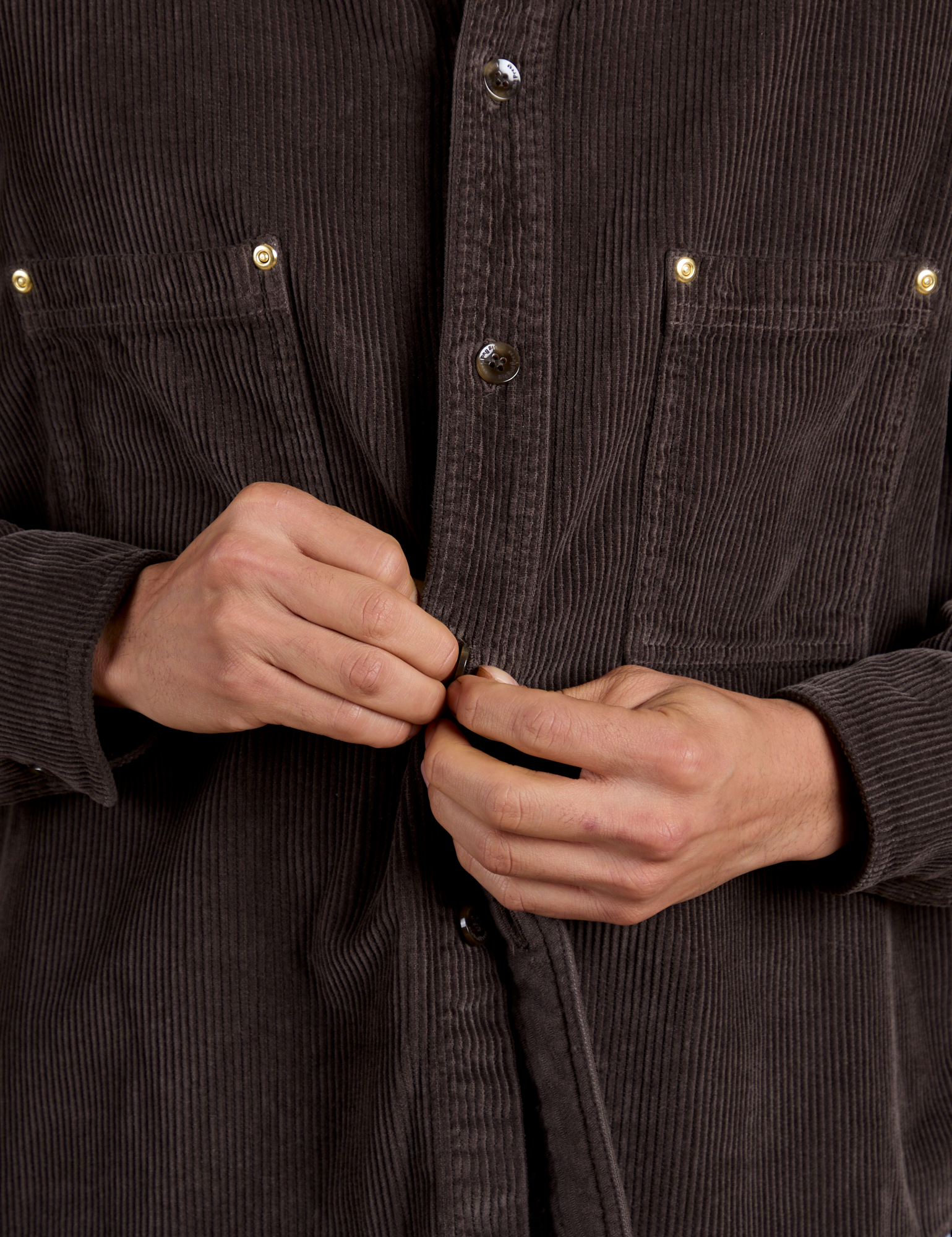 Cropped Corduroy Overshirt in Espresso Brown close up of Anthony buttoning up the shirt