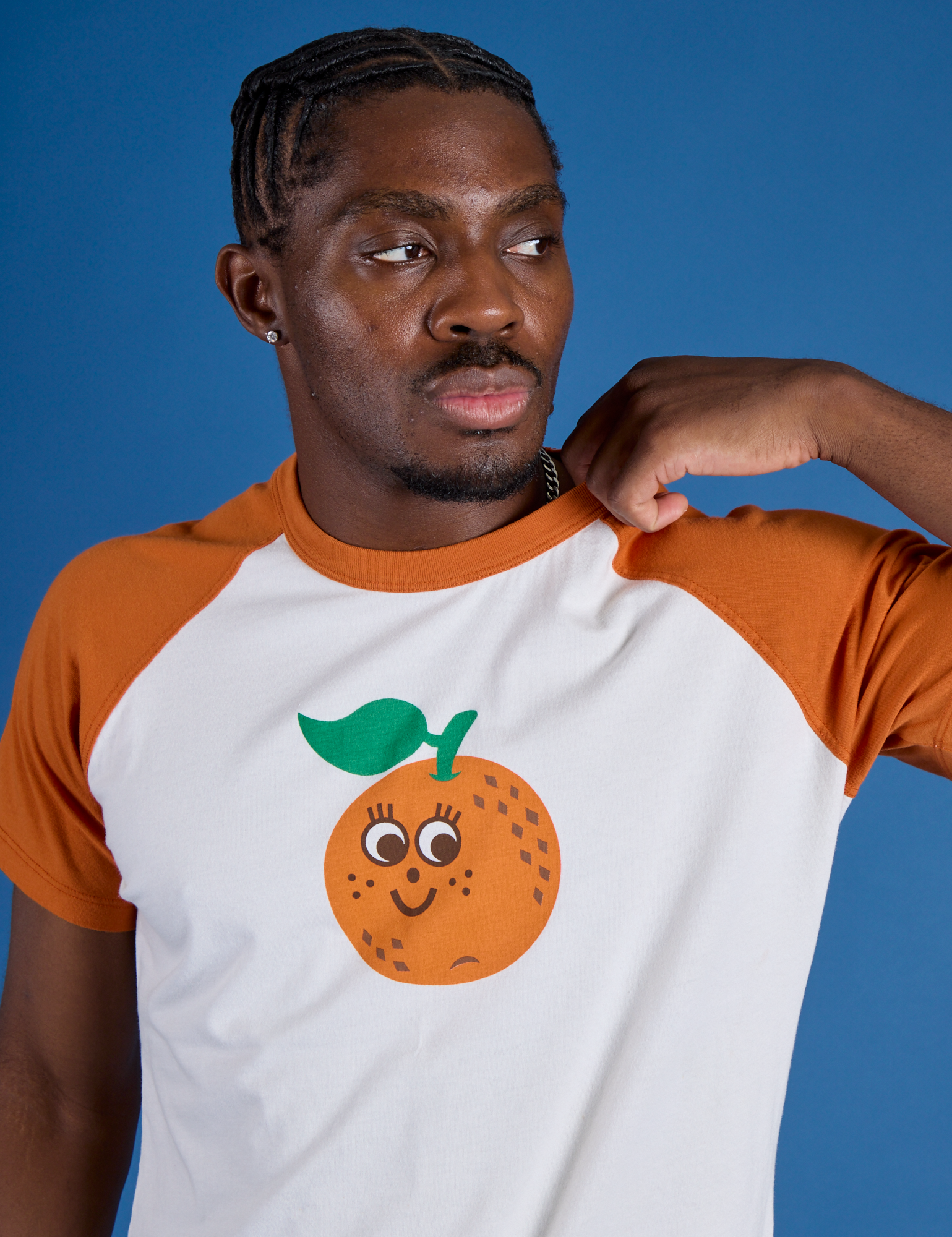 Front close up of Produce Raglan Tee in Orange on Isaac