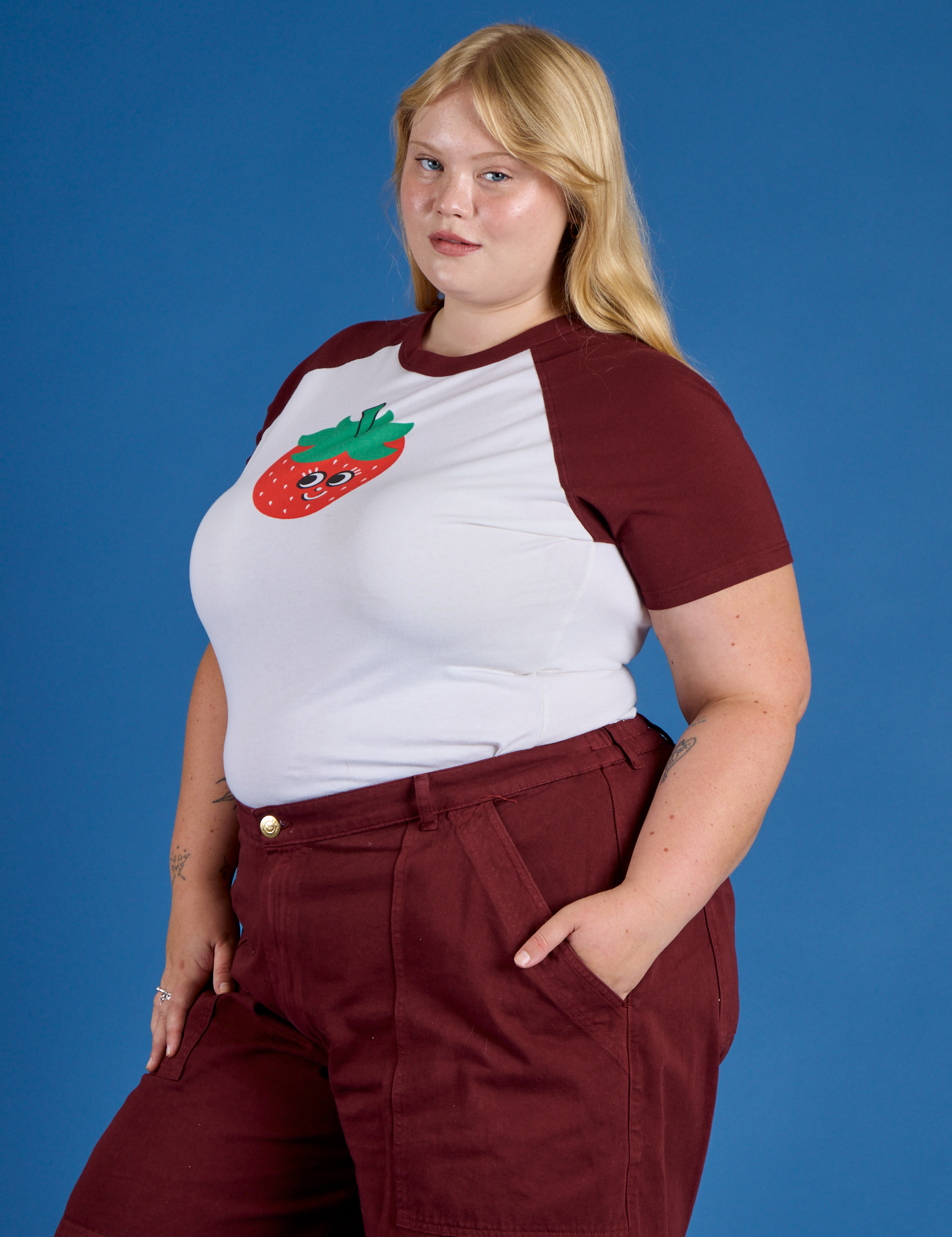 Angled front view of Produce Raglan Tee in Strawberry on Juliet