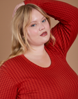 Angled front view close up of Gingham Long Sleeve Baby Tee in Mustang Red on Juliet