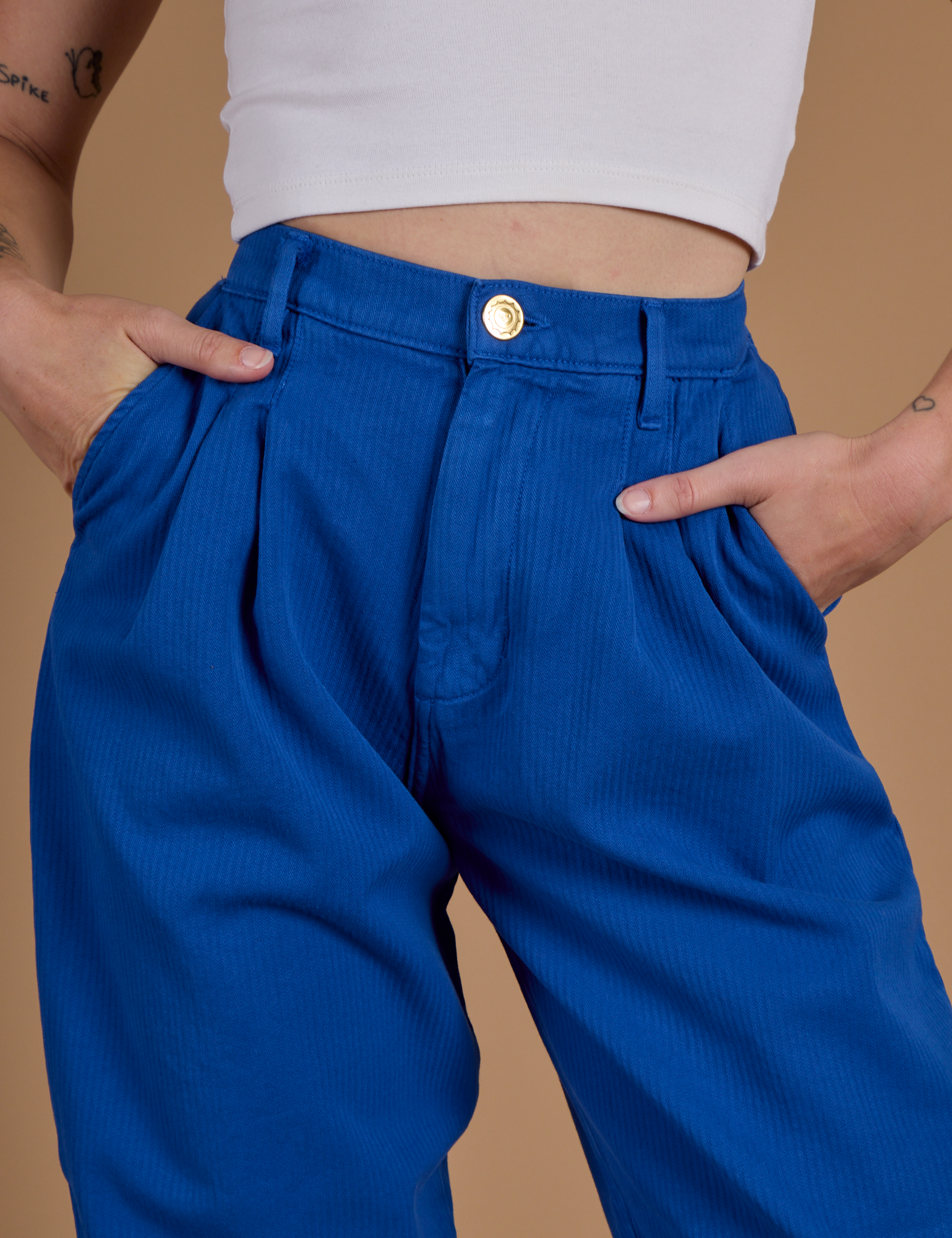 Close up of Alex's hands in the front pockets of Heritage Trousers in Royal Blue