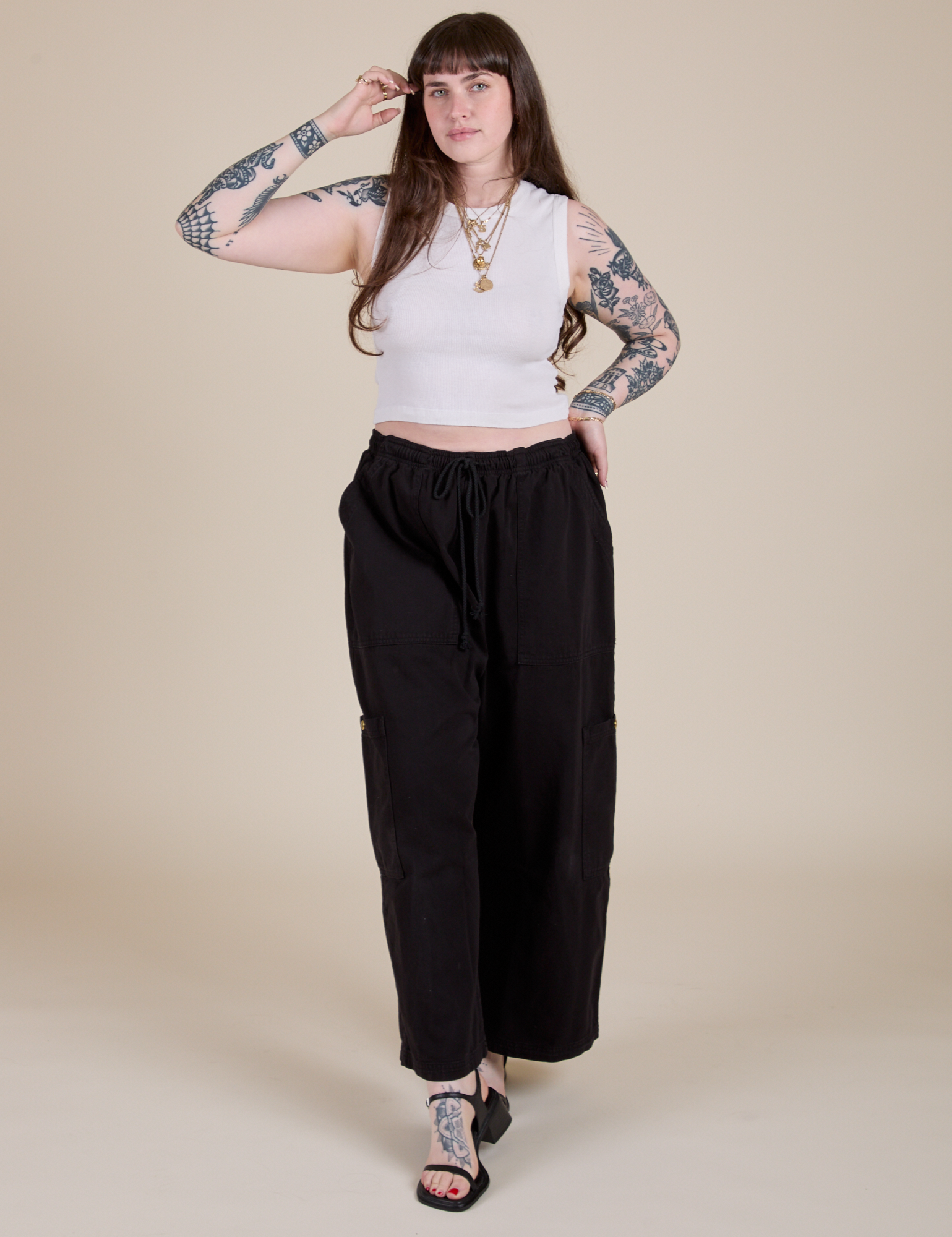 Sydney is wearing Muscle Tee in Vintage Tee White paired with black Drop Pocket Cargo Pants