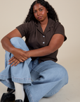 Meghna is wearing Pantry Button-Up in Espresso Brown and light wash Indigo Wide Leg Trousers