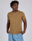 Isaac is 5’10” and wearing M Jr. Varsity Tee in Desert Brown