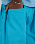 Close up of Isaac's hand in the back pocket of Drop Pocket Cargo Pants in Hawaiian Blue