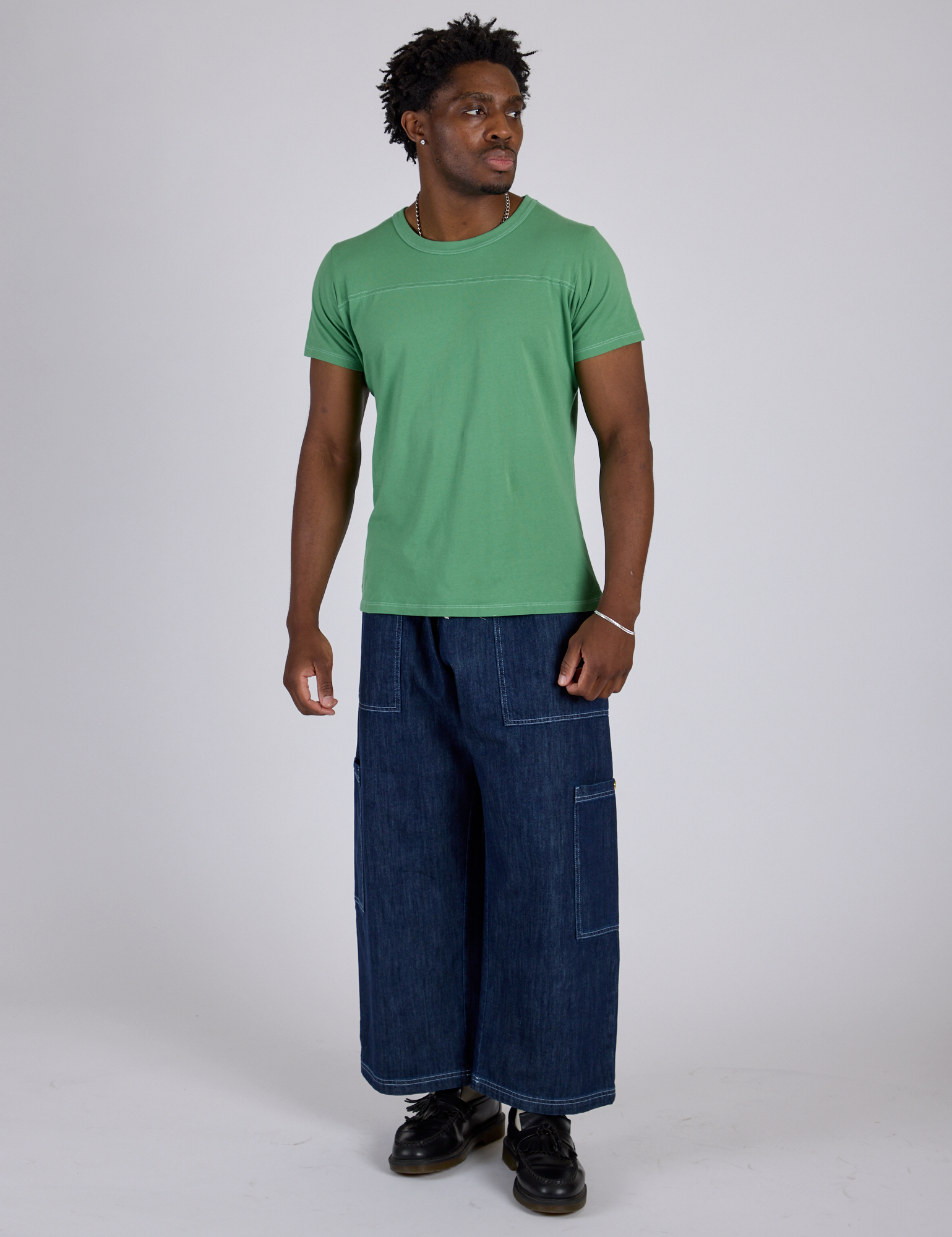 Isaac is wearing Jr. Varsity Tee in Seafoam Green and dark wash Denim Drop Pocket Pants