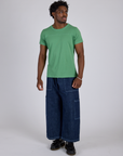 Isaac is wearing Jr. Varsity Tee in Seafoam Green and dark wash Denim Drop Pocket Pants