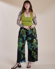 Sydney is 5'9" and wearing L for an oversized look Magic Waters Drop Pocket Pants in Green Pool paired with a gross green Cropped Tank
