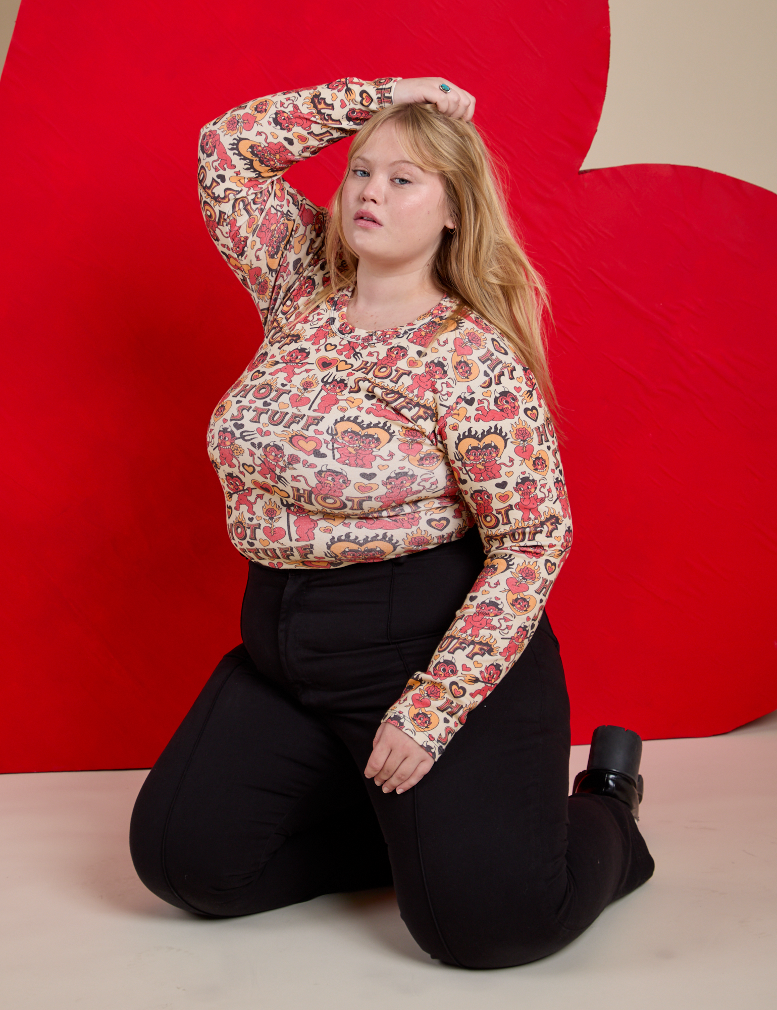 Juliet is wearing Long Sleeve Baby Tee in Hot Stuff Print and Western Pants in Black