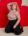 Juliet is wearing Long Sleeve Baby Tee in Hot Stuff Print and Western Pants in Black