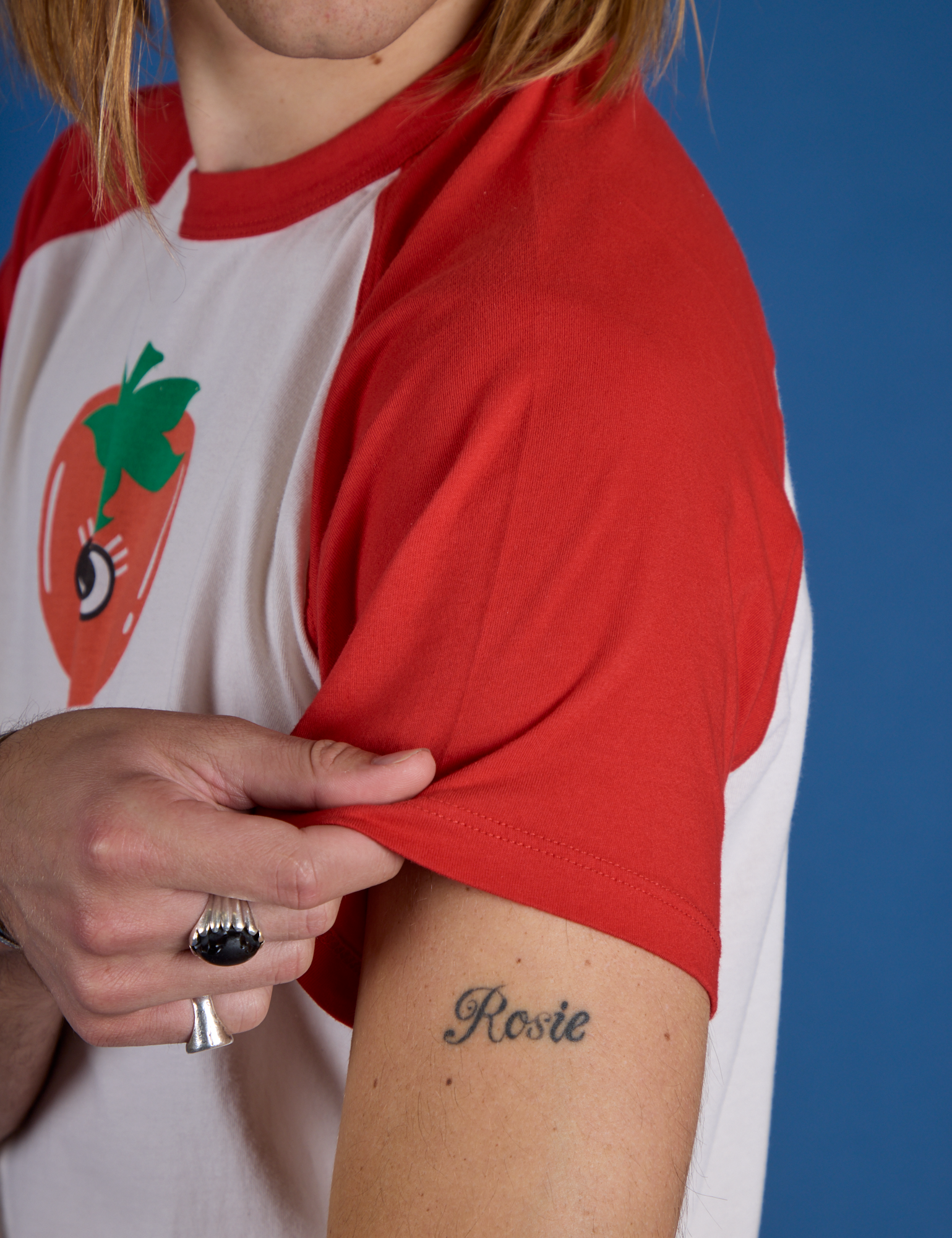 Close up of Produce Raglan Tee in Tomato sleeve on Grant