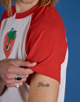Close up of Produce Raglan Tee in Tomato sleeve on Grant