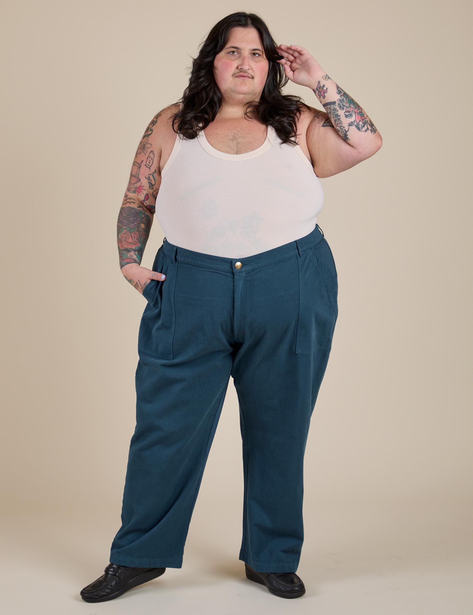 Sam is wearing Work Pants in Lagoon and vintage tee off-white Tank Top
