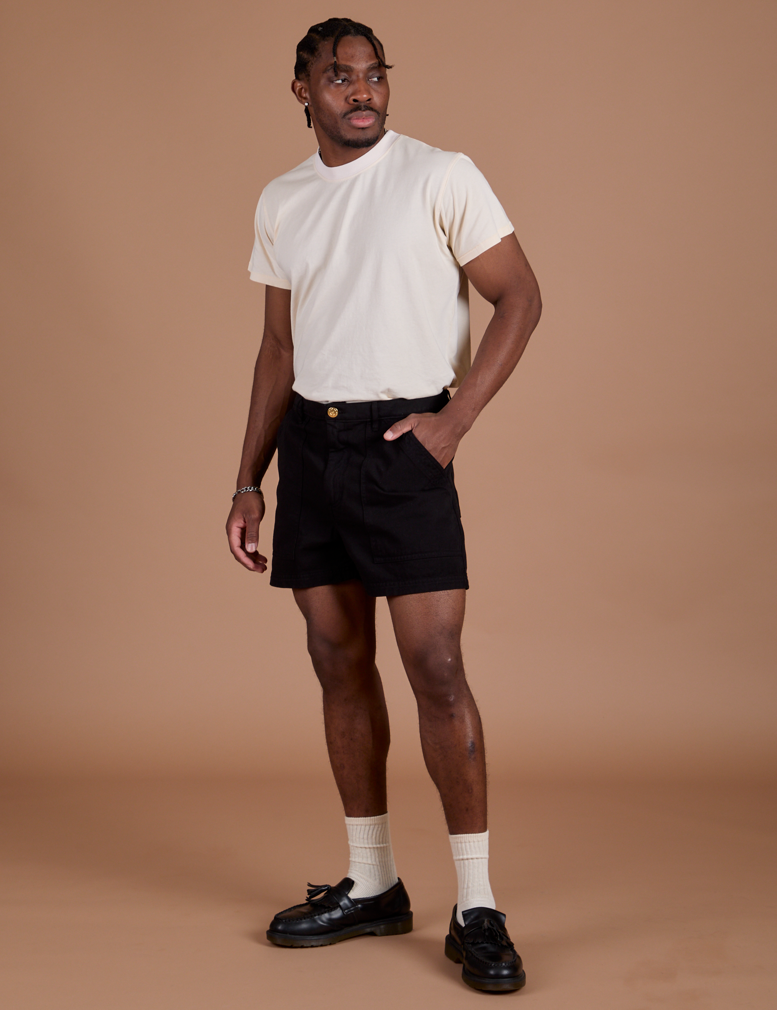 Angled front view of Classic Work Shorts in Basic Black and Organic Vintage Tee in Vintage Off White on Isaac