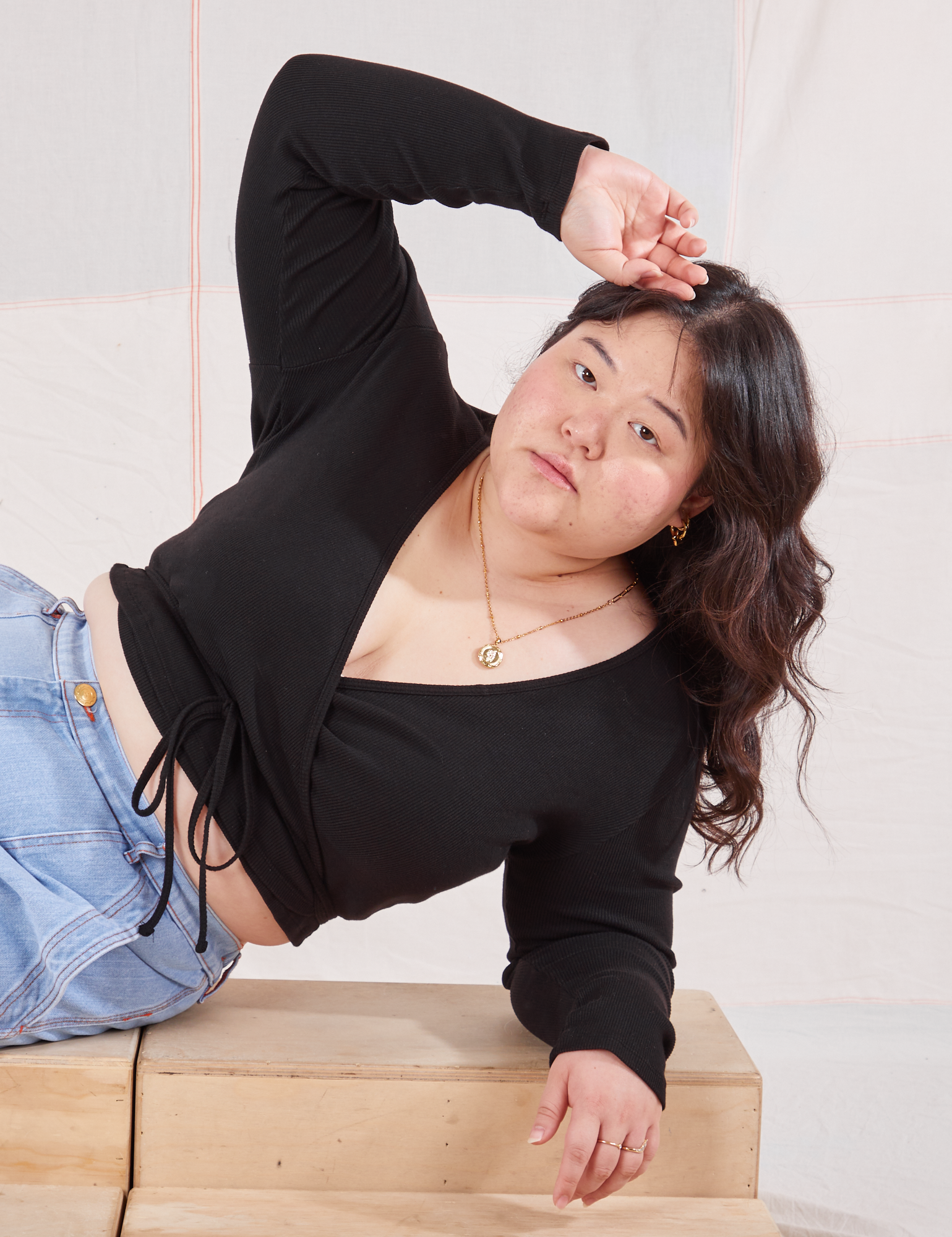 Ashley is wearing Wrap Top in Basic Black
