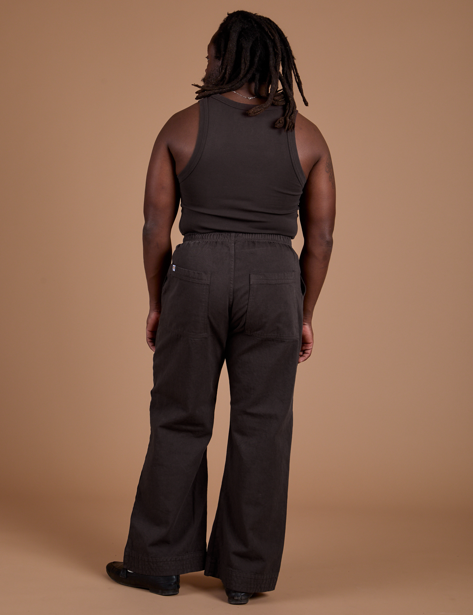 Back view of Work Pants in Espresso Brown and matching Tank Top on Demi