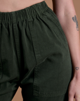 Action Pants in Swamp Green front close up on Alex