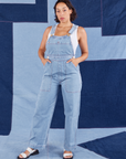 Tiara is 5'4" and wearing XS Indigo Denim Original Overalls in Light Wash