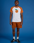 Isaac is wearing Produce Raglan Tee in Orange