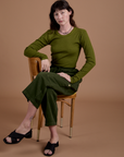 Alex is wearing Gingham Long Sleeve Baby Tee in Summer Olive and Drop Pocket Cargo Pants in Evergreen