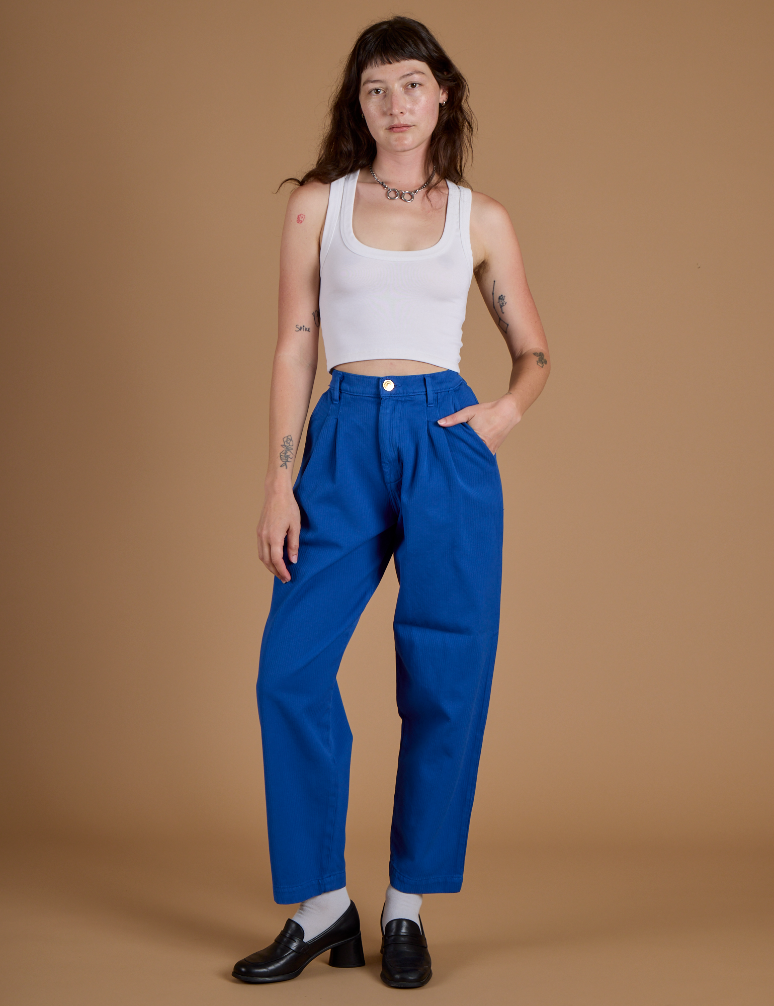 Alex is wearing Heritage Trousers in Royal Blue and vintage tee white Cropped Tank