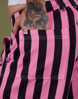 Close up of Jesse's hand in the back pocket of Longline Work Shorts in Bubblegum Pink