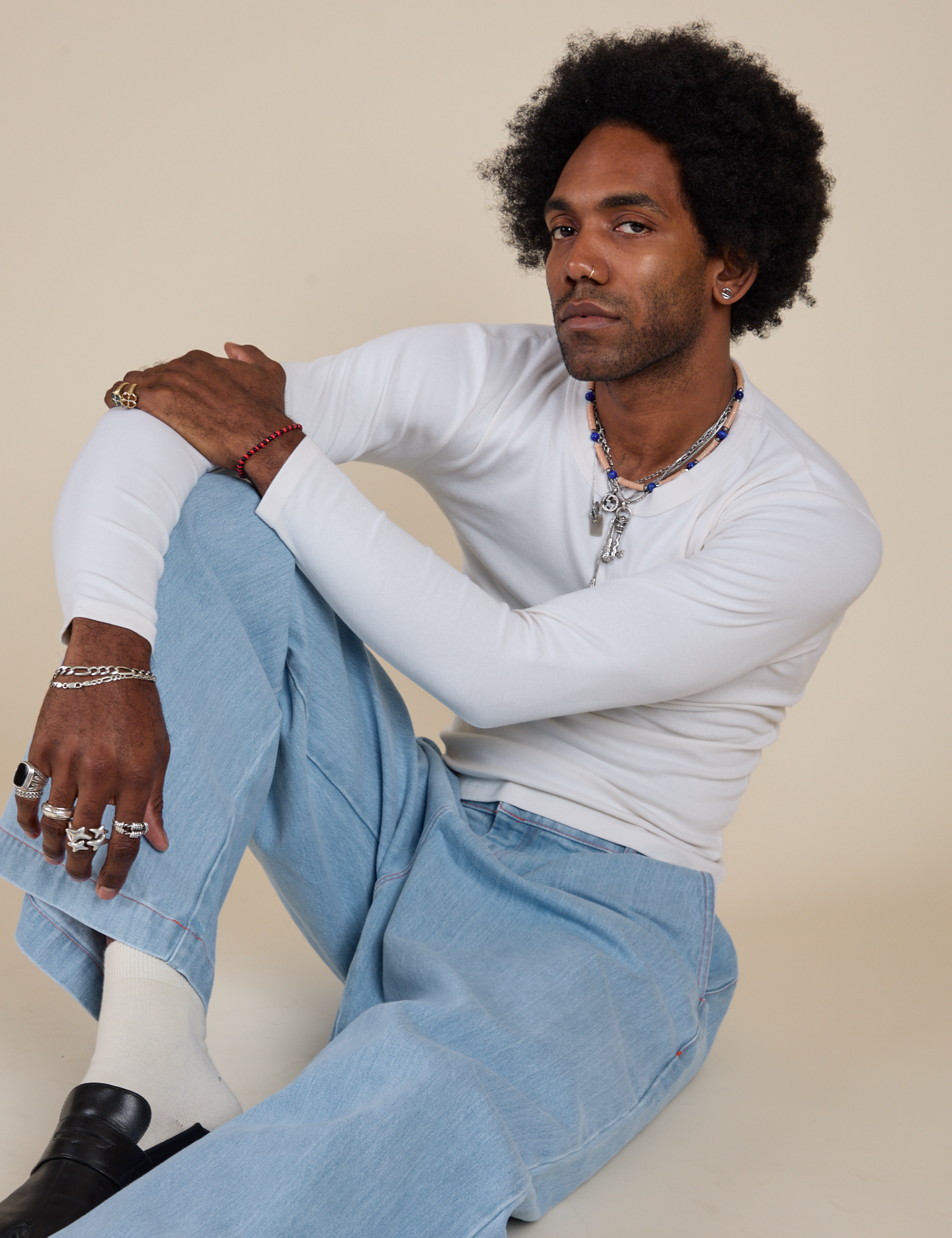 Jerrod is wearing Long Sleeve Baby Tee in Vintage Tee Off-White