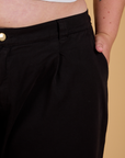 Close up of Juliet's hand in the front pocket of Baggy Mid-Rise Trousers in Basic Black