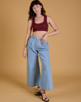 Alex is wearing Mini Tank in Red Wine and light wash Indigo Wide Leg Trousers