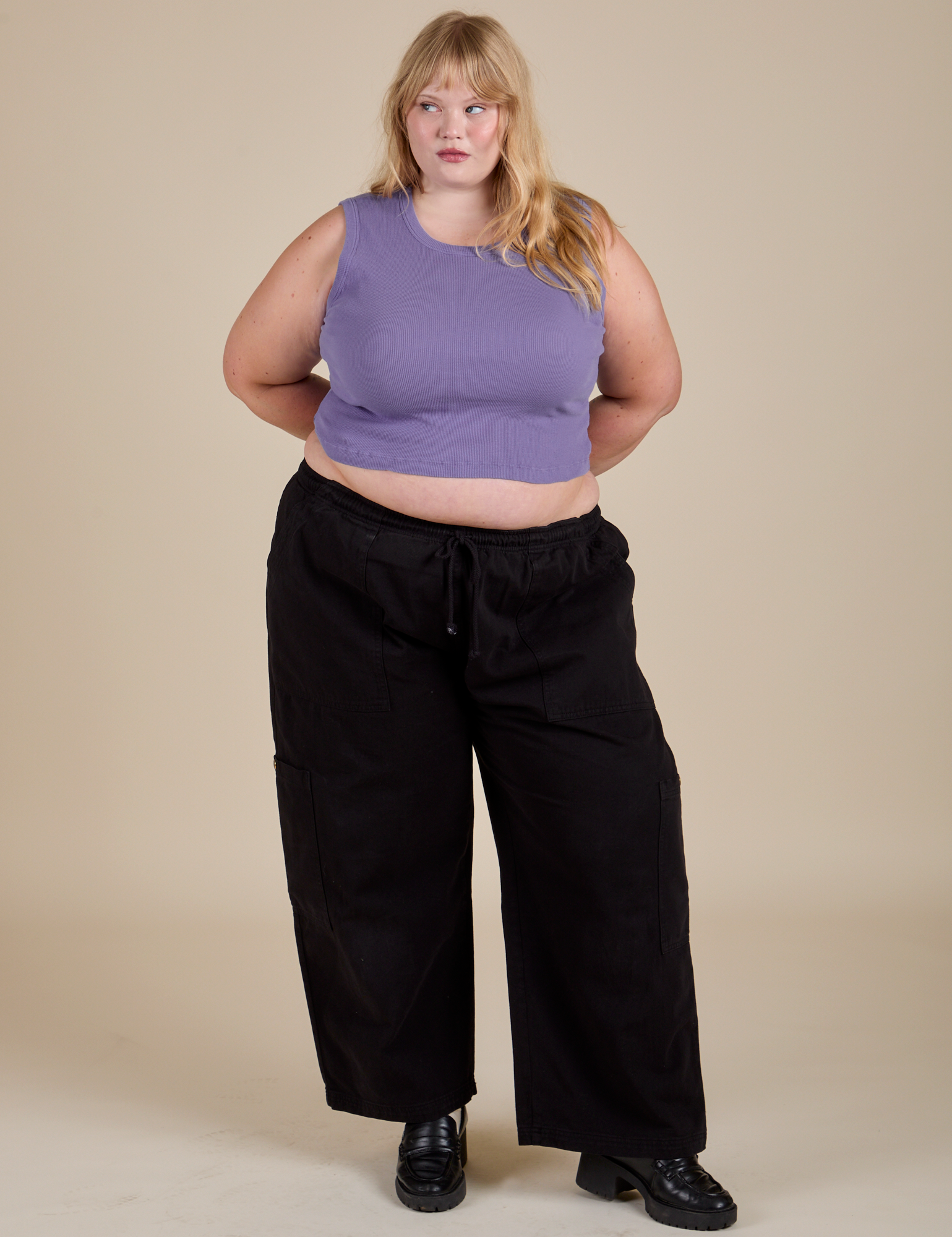 Juliet is wearing Muscle Tee in Faded Grape and black Drop Pocket Cargo Pants