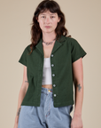Alex is 5’8” and wearing P Pantry Button-Up in Swamp Green