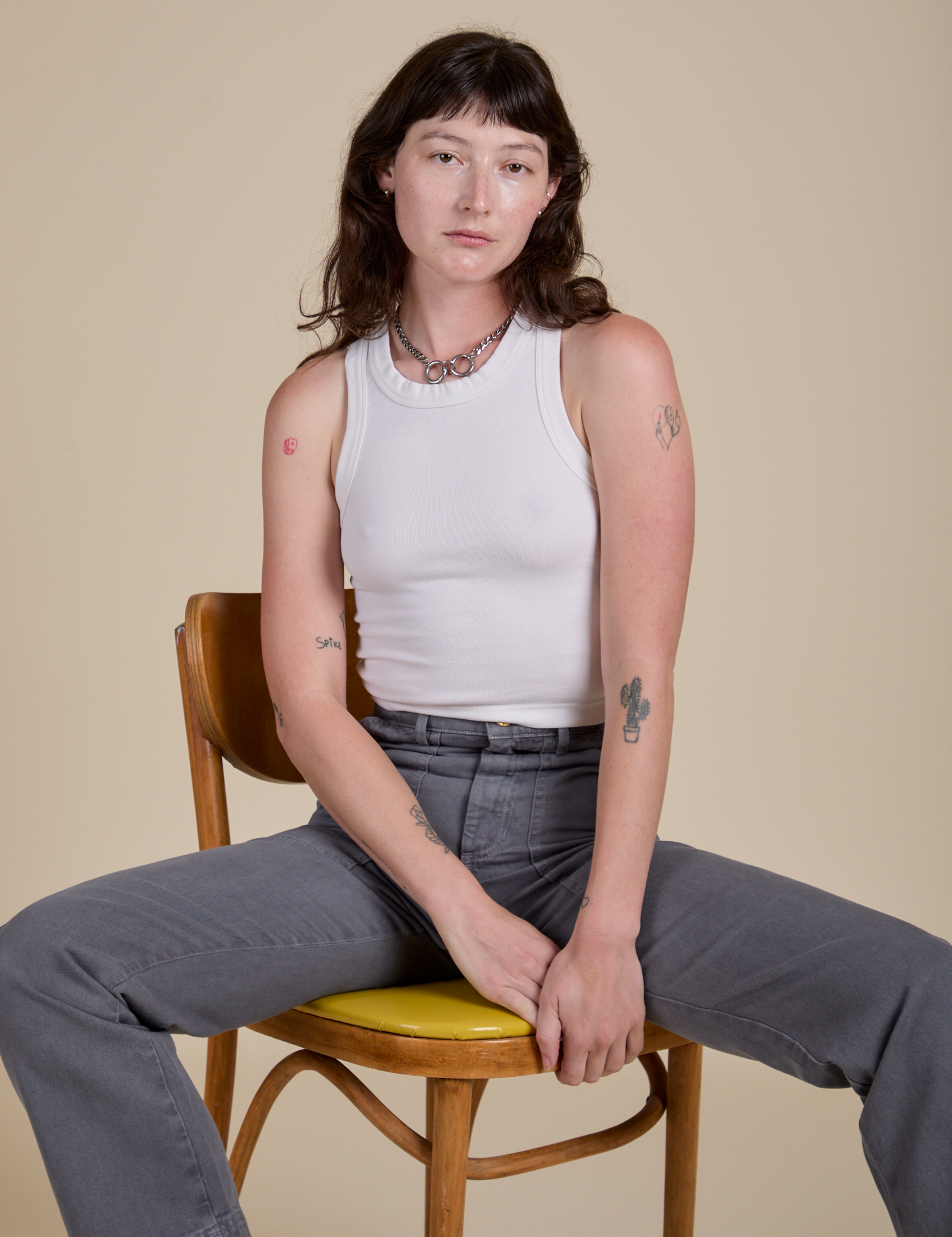 Alex is wearing Racerback Tank in Vintage Tee White and washed grey Work Pants