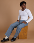 Isaac is wearing Railroad Denim Work Pants in Natural and vintage tee white Long Sleeve Baby Tee