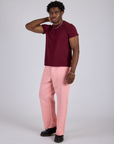 Angled front view of Work Pants in Baby Pink and red wine Organic Vintage Tee on Isaac