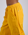 Drop Pocket Cargo Pants in Sunshine Yellow side view close up on Kira