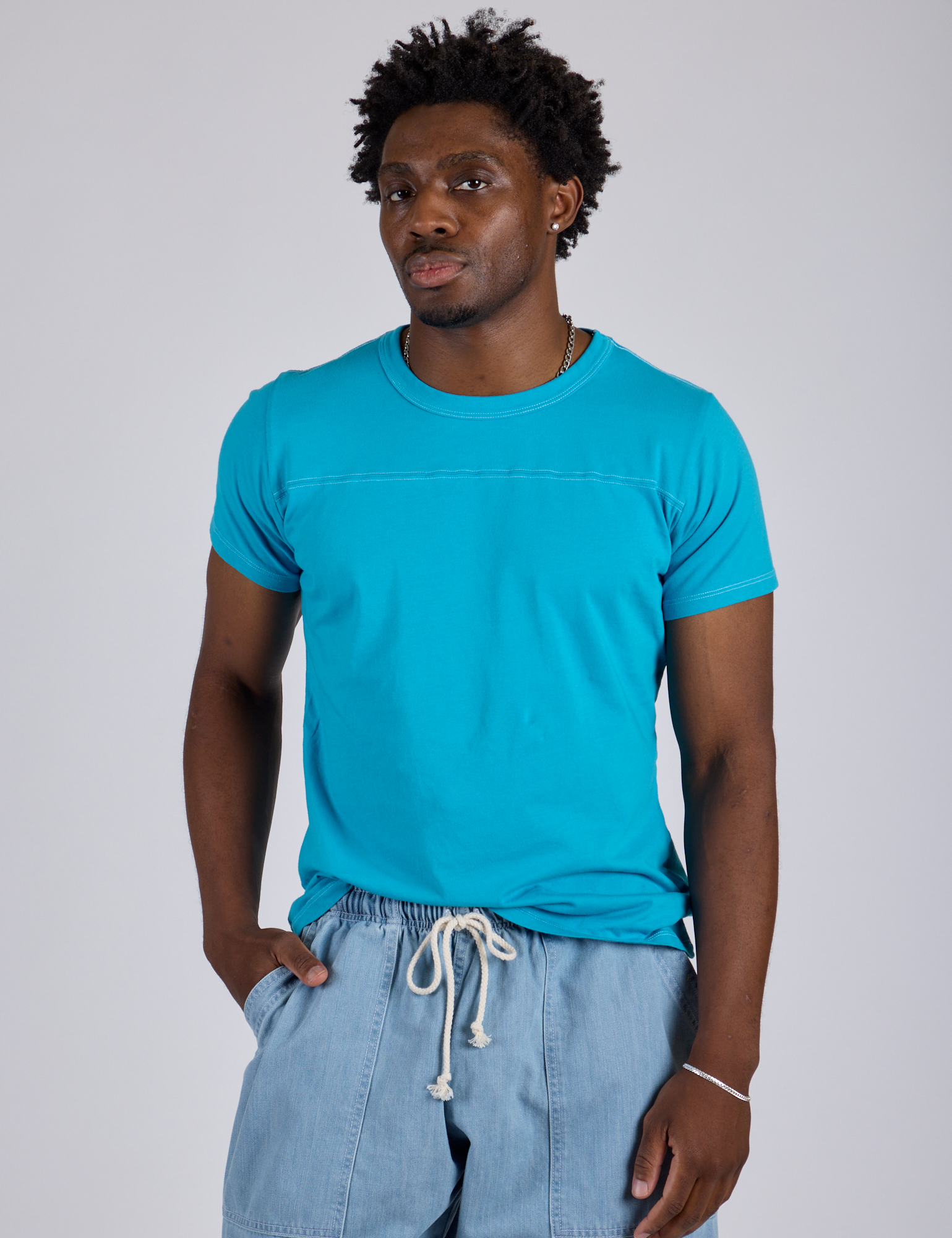 Isaac is wearing Jr. Varsity Tee in Hawaiian Blue