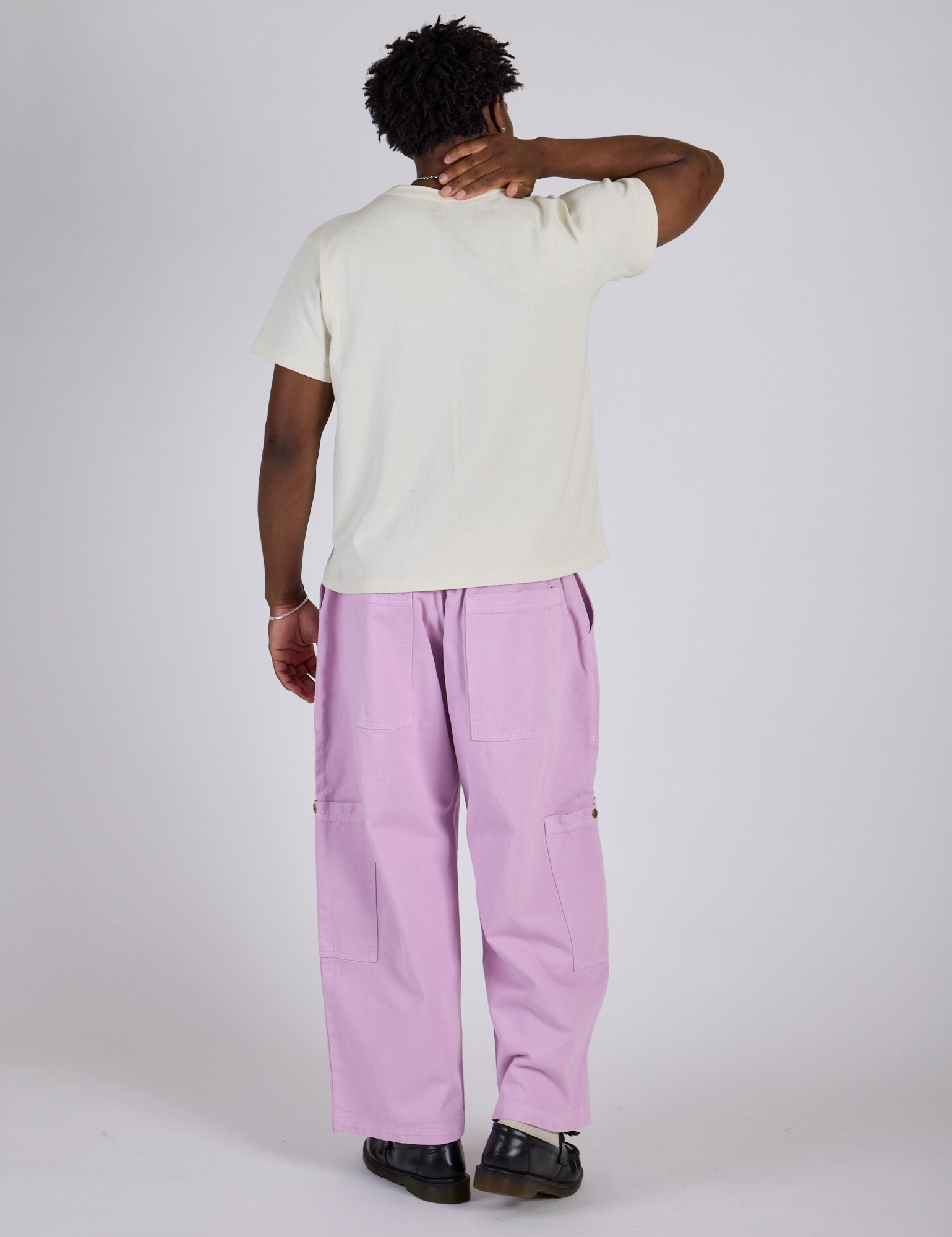 Back view of Drop Pocket Cargo Pants in Lilac Purple and Organic Vintage Tee in Vintage Tee White on Isaac