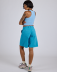 Angled back view of Longline Work Shorts in Hawaiian Blue and baby blue Racerback Tank