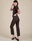 Angled back view of Short Sleeve Jumpsuit in Espresso Brown on Alex