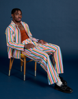 Isaac is wearing Stripe Work Jacket in Rainbow Striped matching Work Pants