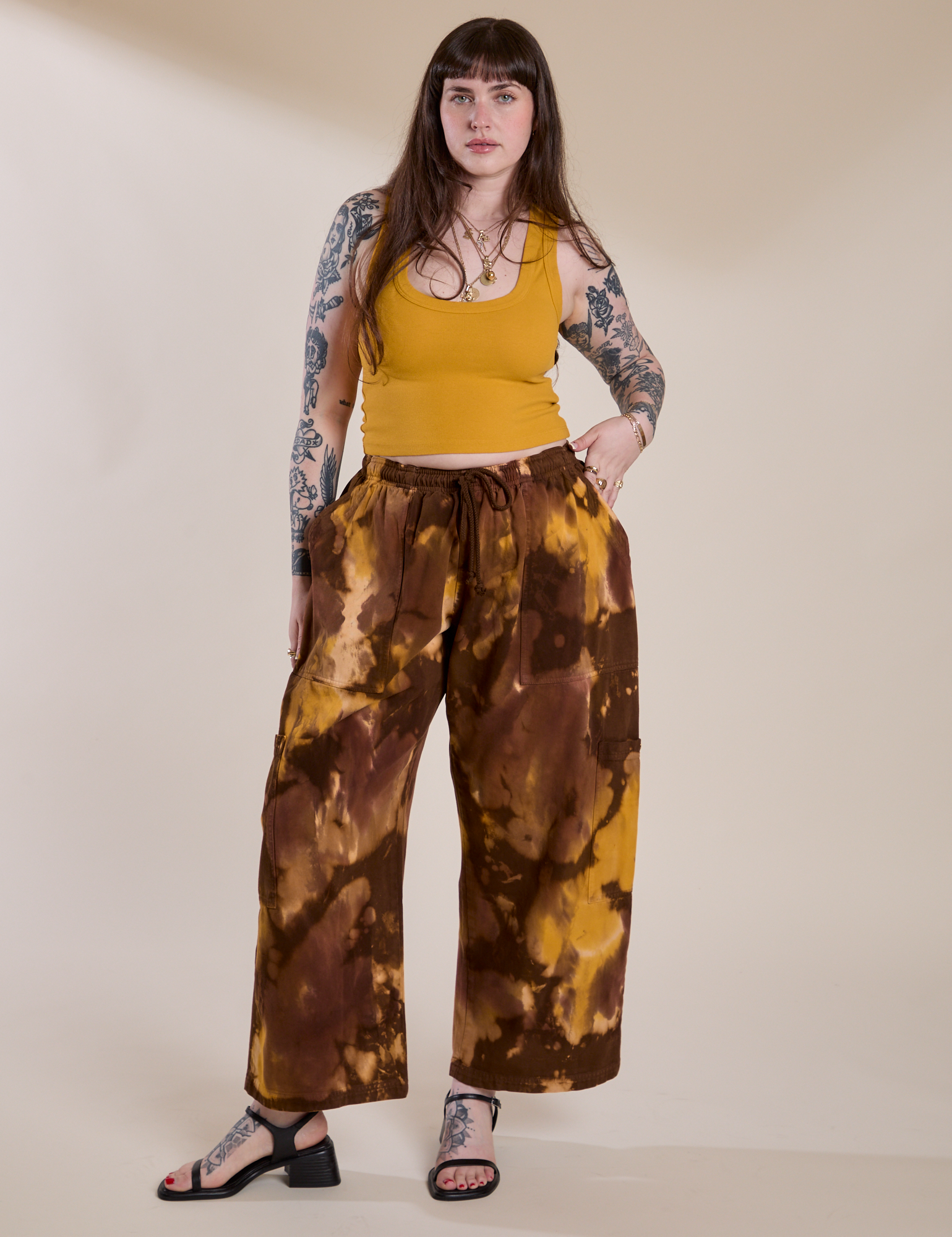 Sydney is 5'9" and wearing L for an oversized look Magic Waters Drop Pocket Pants in Honey Brown paired with mustard yellow Cropped Tank