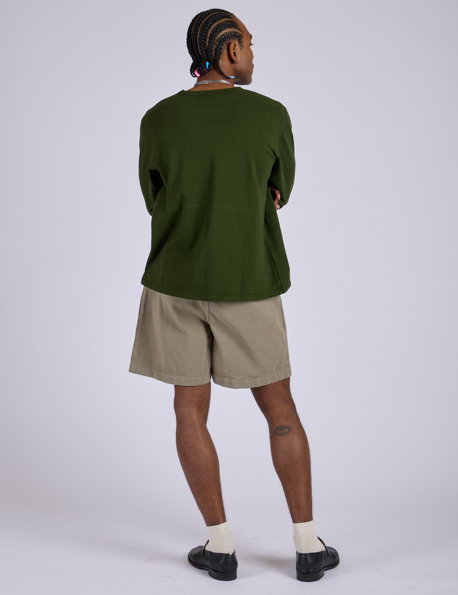 Back view of Pleated Trouser Shorts in Khaki Grey and evergreen Long Sleeve Burly Tee