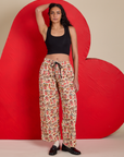 Shahana is 5’10 and wearing XS Hot Stuff Drop Pocket Cargo Pants paired with a black Cropped Tank